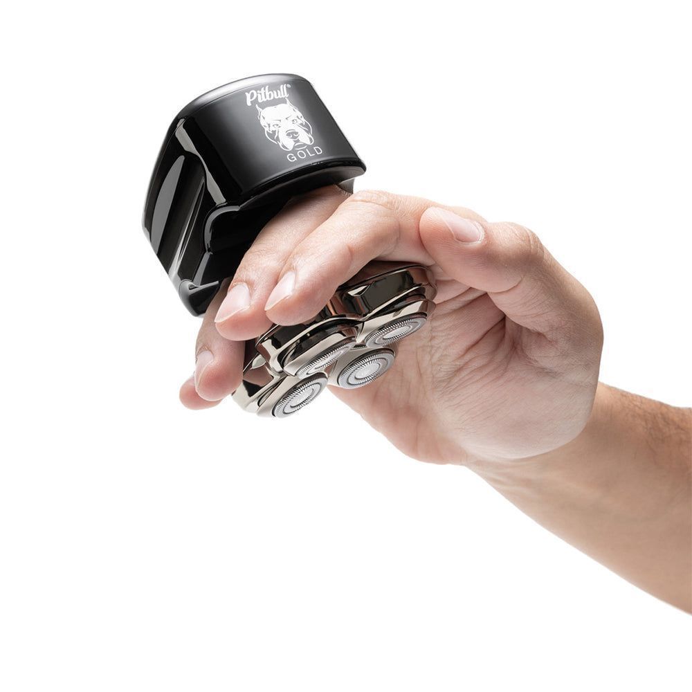 a man using skull shaver pitbull gold pro shaver on head for smooth shave